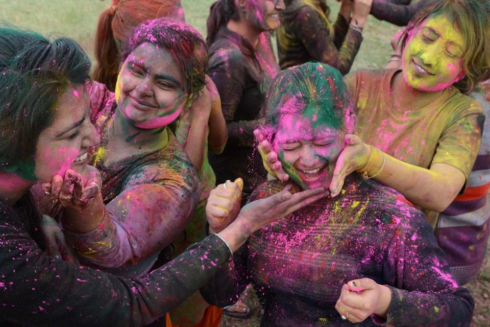 Hindus celebrate Holi by throwing colourful powdered paint on each other (Getty )