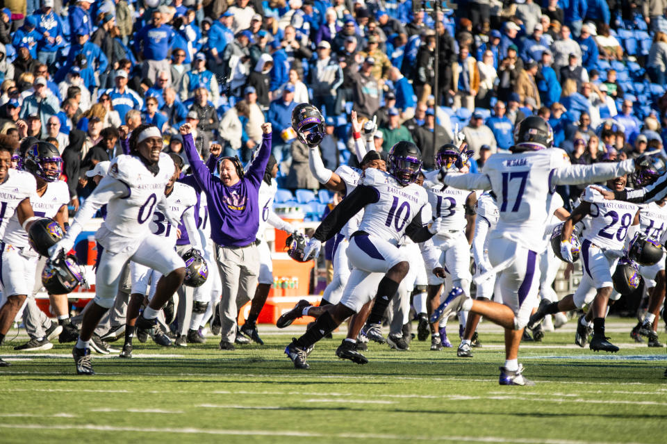 The East Carolina football team storms the field at Liberty Bowl Memorial Stadium on Nov. 13, 2021, after defeating AAC opponent Memphis on the road. The 30-29 overtime win was ECU's sixth of the season and clinched the program's first bowl appearance since 2014.