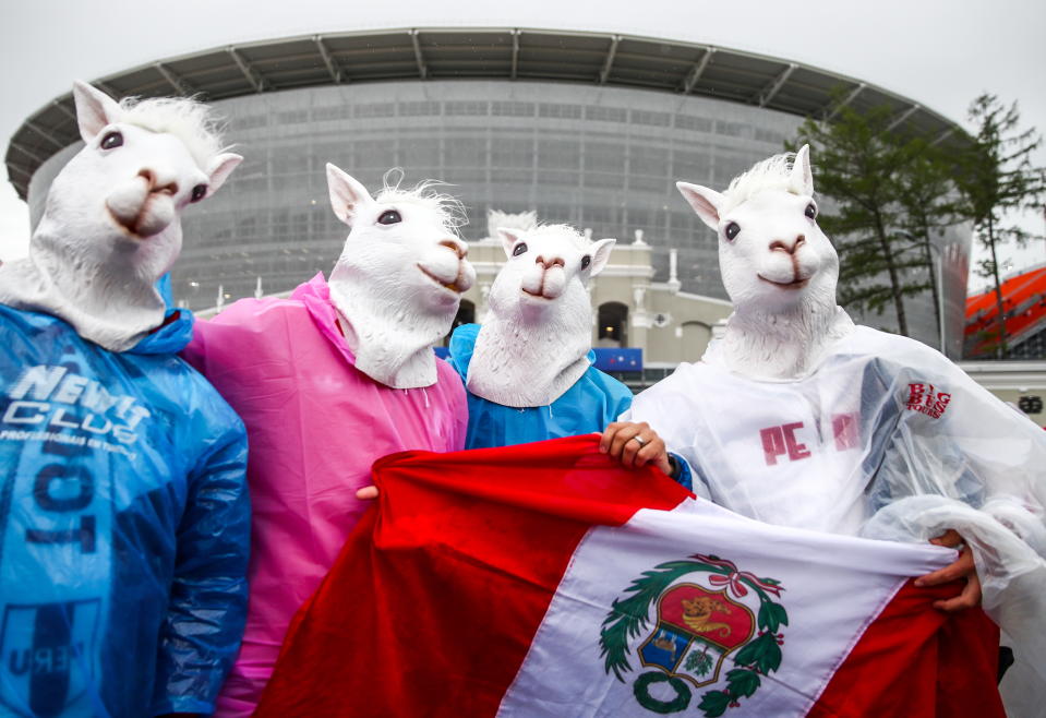 <p>Peru-ving themselves: Peru fans get in on the act before their opening fixture against Denmark. (Getty) </p>