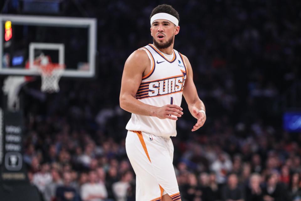 Phoenix Suns guard Devin Booker (1) argues over a call in the first quarter against the New York Knicks at Madison Square Garden on Nov. 26, 2023.