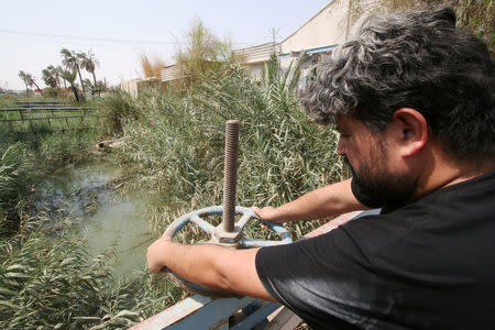 A worker adjusts valve at Al-buradieiah Water Treatment Plant damaged on the banks of the Shatt al-Arab in Basra, Iraq September 17, 2018. REUTERS/Essam al-Sudani/Files