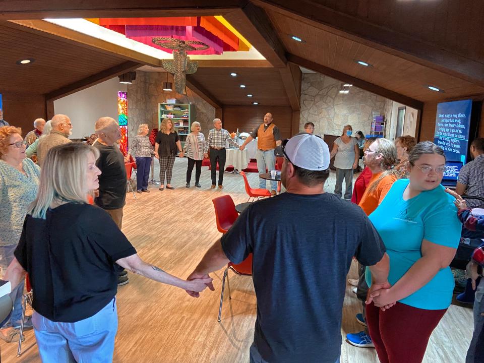 Attendees form a circle to pray together at the Clark Memorial United Methodist Church deconsecration service in Oklahoma City.