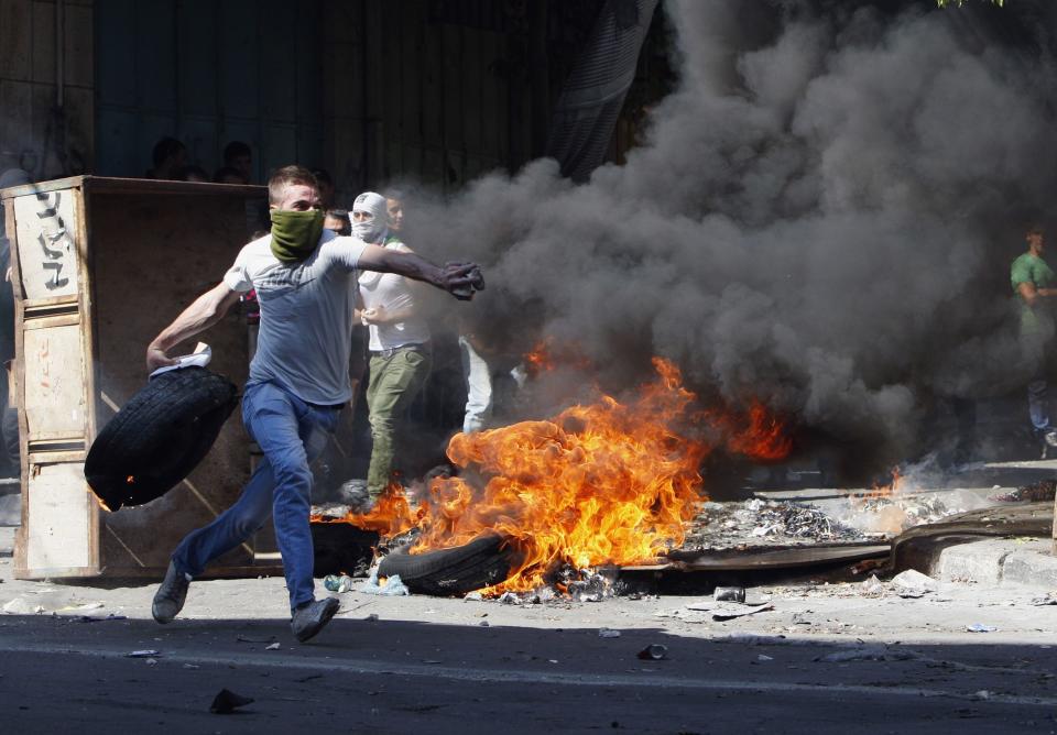 Palestinian protesters clash with Israeli security forces during clashes in West Bank city of Hebron