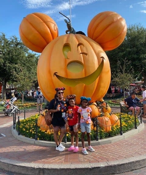 author and her kids in front of the large pumpkin