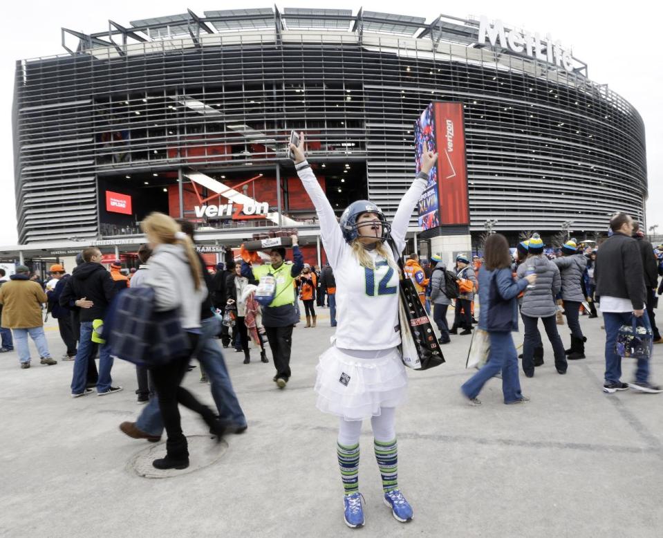 Lacey Surprenat of Seattle cheers outside MetLife Stadium before the NFL Super Bowl XLVIII football game Sunday, Feb. 2, 2014, in East Rutherford, N.J. (AP Photo/Julio Cortez)