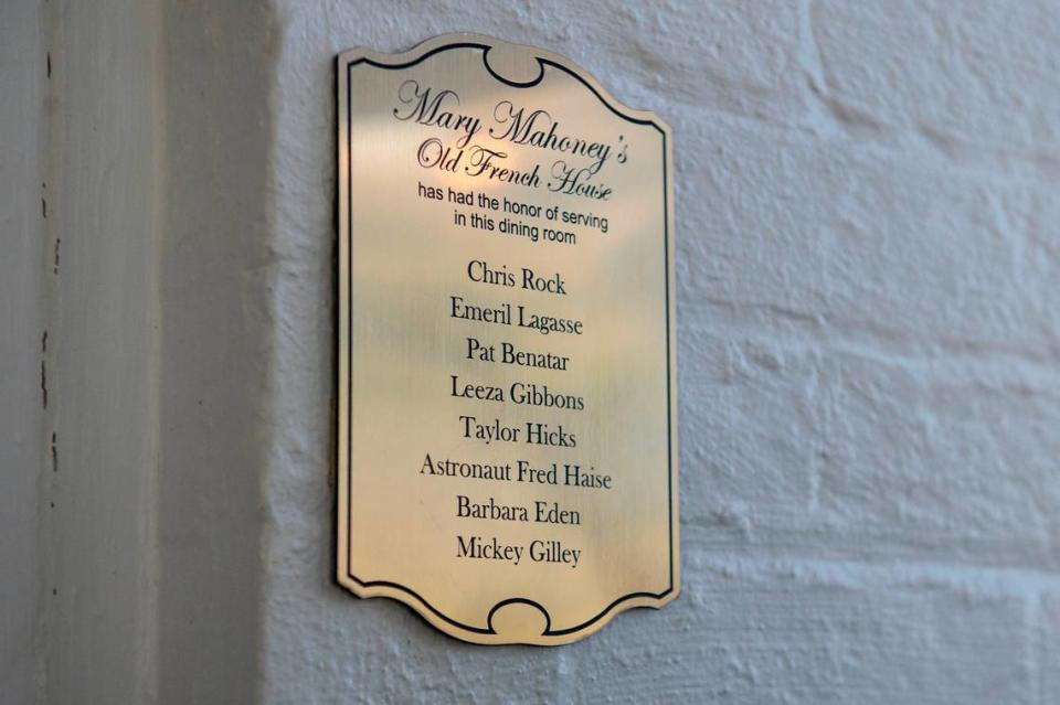 Plaques hang near the doorways of each dining room inside Mary Mahoney’s listing the celebrities who have dined in that room. One of the plaques listing celebrities like Emeril Lagasse hangs in the restaurant on Friday, Jan. 27, 2023.