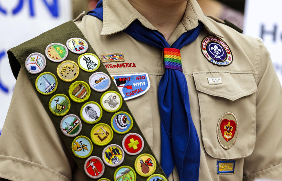 Merit badges and a rainbow-colored neckerchief slider on a Boy Scout uniform. (Ted S. Warren / AP file)