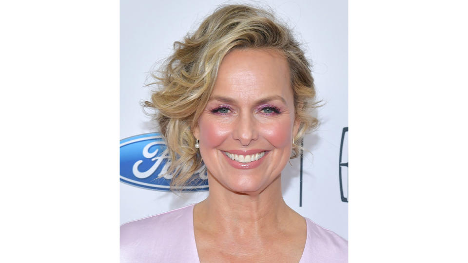 Melora Hardin with short, curled hair, which you can do too after learning how to curl short hair