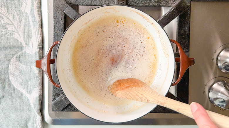 Brown butter in saucepan with wooden spoon stirring