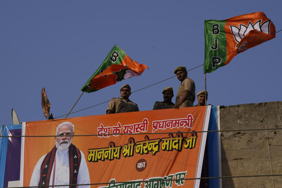 Security people stand guard on the top of a building during Indian Prime Minister Narendra Modi's election campaign for the upcoming national elections in Ghaziabad, India, April 6, 2024. India is in election mode with colorful, and frenzied, campaign underway by various political parties to woo voters across the country. From April 19 to June 1, nearly 970 million Indians or over 10% of the global population are eligible to vote in India's general election. (AP Photo/ Manish Swarup)