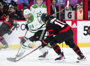 Dallas Stars' Tanner Kero (64) pokes the puck between the skates of Ottawa Senators' Alex Formenton (10) during the first period of an NHL hockey game, Sunday, Oct. 17, 2021, in Ottawa, Ontario. (Sean Kilpatrick/The Canadian Press via AP)