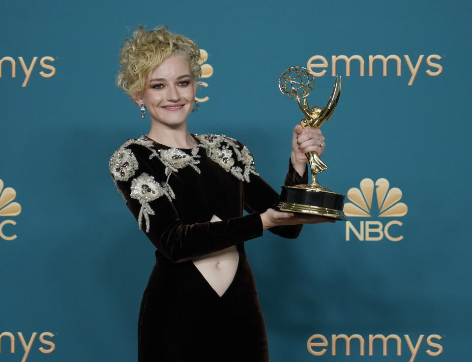 Julia Garner poses in the pressroom with the award for outstanding supporting actress in a drama series at the 74th Primetime Emmy Awards on Monday, Sept. 12, 2022, at the Microsoft Theater in Los Angeles. (AP Photo/Jae C. Hong)