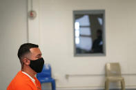 Immigration detainee Alexander Martinez speaks during an interview with The Associated Press, while ICE and facility personnel wait outside in the hallway, at the Winn Correctional Center in Winnfield, La., Friday, July 30, 2021. The number of people in federal immigration detention has risen markedly under President Joe Biden. (AP Photo/Gerald Herbert)