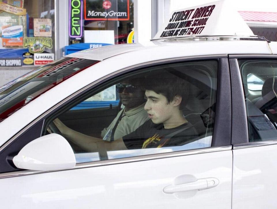 Asher Philips, 15, runs through a driving checklist alongside instructor Curtis Wilson during the behind-the-wheel portion of the driver’s education program run by Jordan Driving School on Aug. 19, 2015.