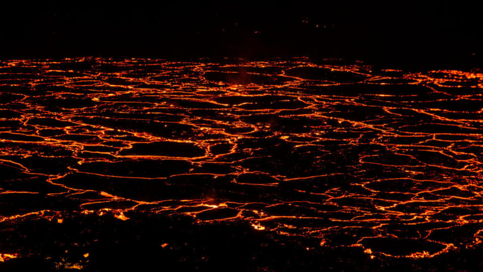 molten lava coming out of cracks in the ground.