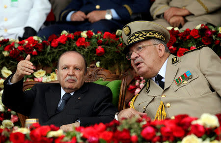 FILE PHOTO: Algeria's President Abdelaziz Bouteflika gestures while talking with Army Chief of Staff General Ahmed Gaed Salah during a graduation ceremony of the 40th class of the trainee army officers at a Military Academy in Cherchell 90 km west of Algiers, Algeria June 27, 2012. REUTERS/Ramzi Boudina/File Photo