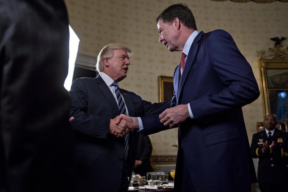 President Donald Trump shakes hands with James Comey, director of the Federal Bureau of Investigation in the Blue Room of the White House on January 22, 2017, in Washington, D.C. | Pool—Getty Images