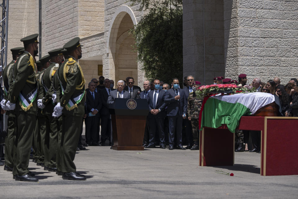 Palestinian President Mahmoud Abbas talks in front of mourners after he laid a wreath of flowers on the body of slain Al Jazeera journalist Shireen Abu Akleh, who was shot dead Wednesday during an Israeli military raid in the West Bank city of Jenin, during an official ceremony at the Palestinian Authority headquarters in Ramallah, Thursday, May 12, 2022. Thousands gathered to mourn Abu Akleh in the occupied West Bank city of Ramallah on Thursday, as the head of the Palestinian Authority blamed Israel for her death and rejected Israeli calls for a joint investigation. (AP Photo/Nasser Nasser)