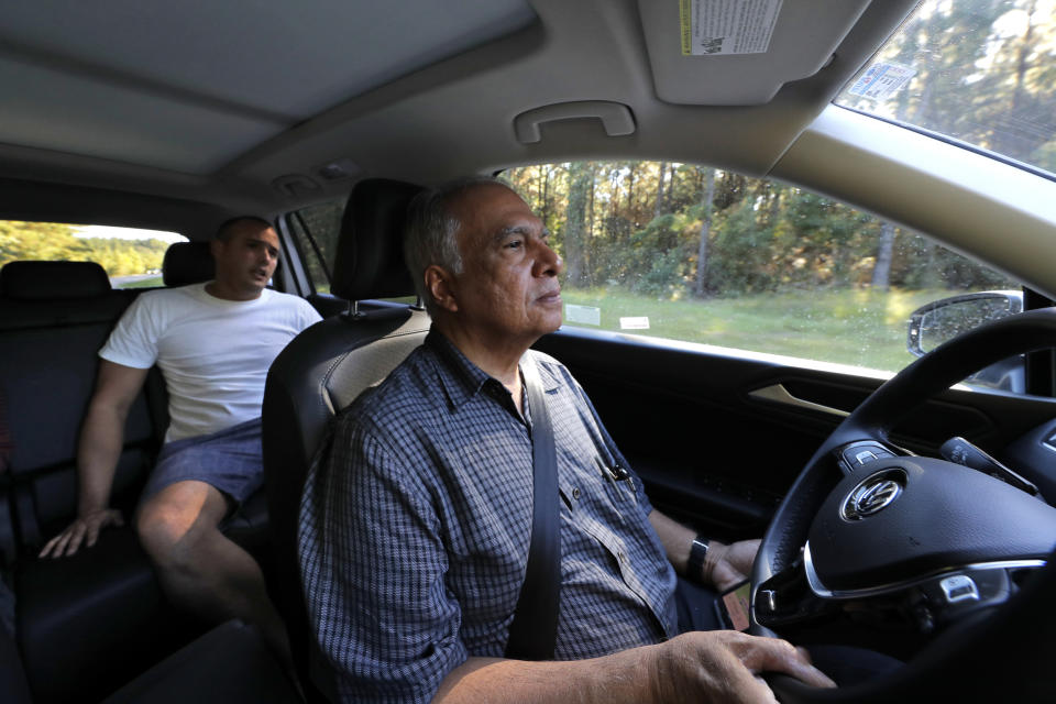 Pedro Cordoves Diaz, a 26-year-old from Cuba who was just released from the Winn Correctional Center, rides in the taxi of Alex Melendez to a bus station over 55 miles away, in Winnfield, La., Thursday, Sept. 26, 2019. Calls for pickups have surged in the last year. He sometimes crosses rural Louisiana to pick people up at four jails in a single day. Melendez says he listens to the stories migrants tell about why they fled their homes or what it was like for them inside. (AP Photo/Gerald Herbert)