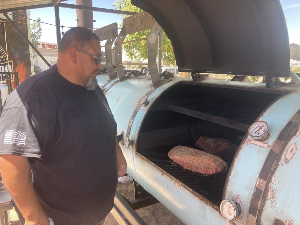 Joe Martinez checks the brisket inside the smoker at his food truck, Smokin' Joe's Pit BBQ. He owns the food truck with his brother Martin Martinez.