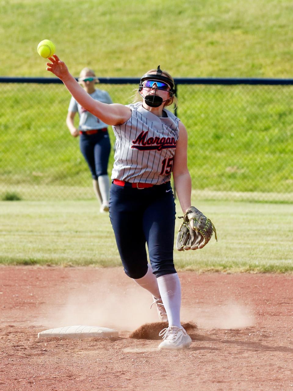 Chloe Baker throws to first base during Morgan's 15-5 win against visiting Coshocton on Monday in McConnelsville.