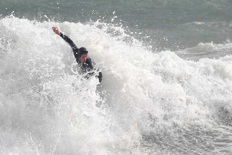 A surfer is seen in action at Cottesloe Beach in Perth.