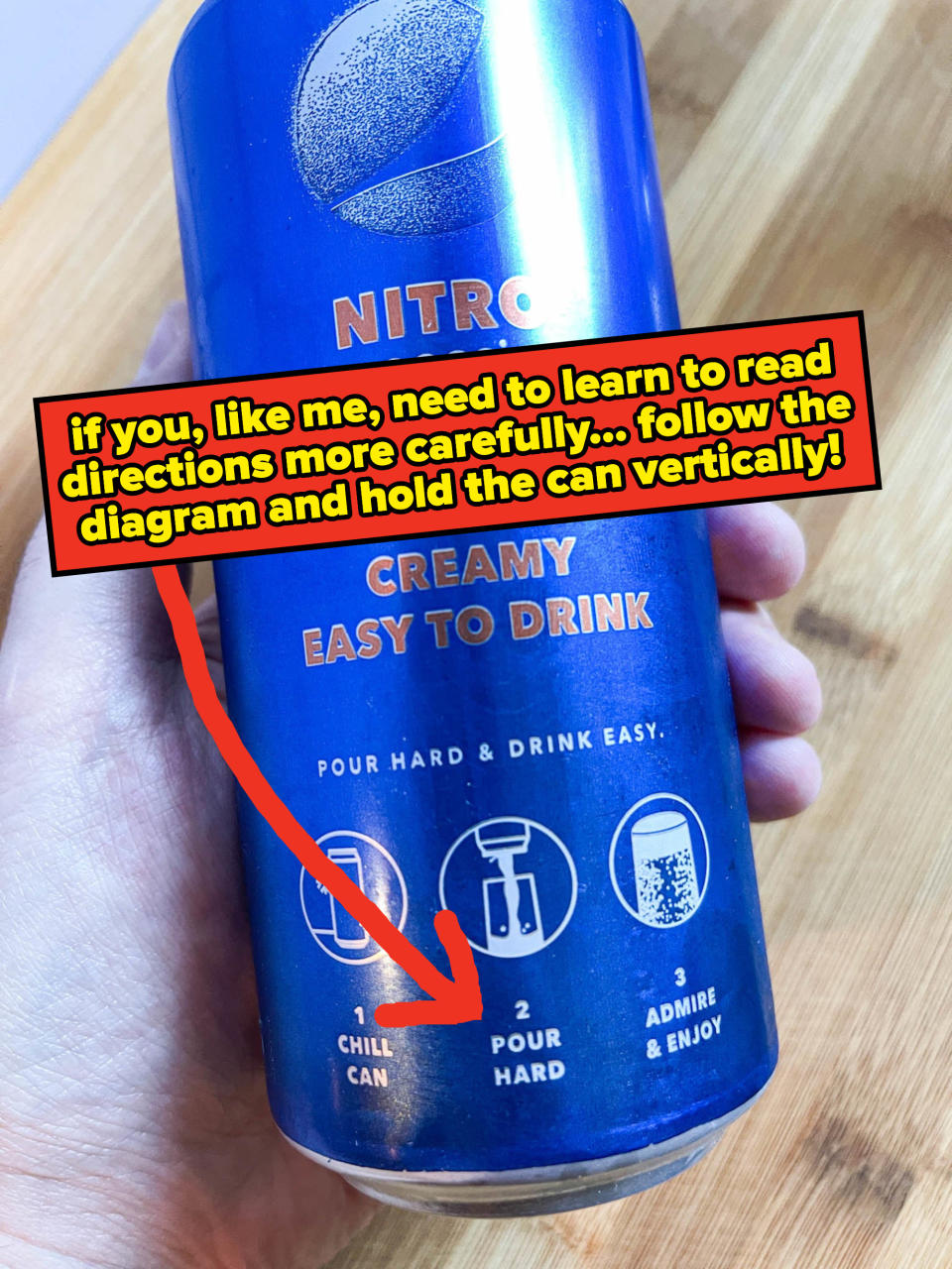 arrow pointing to a direction on the can instructing people to hold can vertically while pouring