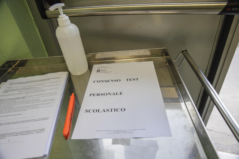 Papers to be signed by school workers to give their consent for a blood COVID-19 test are seen at the San Carlo Hospital in Milan, Italy, Wednesday, Aug. 26, 2020. Despite a spike in coronavirus infections, authorities in Europe are determined to send children back to school. Italy, Europe’s first virus hot spot, is hiring 40,000 more temporary teachers and ordering extra desks, but some won’t be ready until October. (AP Photo/Luca Bruno)