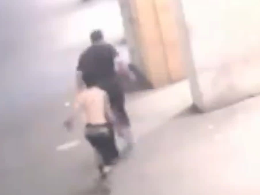 In the footage, a man can be seen running up to the 57-year-old victim before throwing an unknown substance on his back (NYPD)