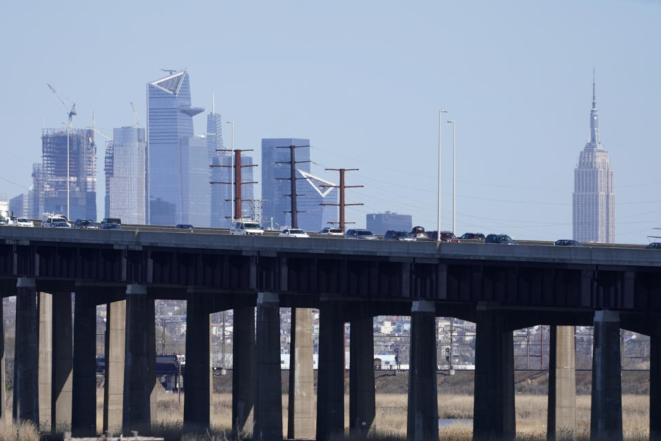 Cars travel on a raised expressway, in front of buildings in both New Jersey and New York, in Kearny, N.J., Tuesday, April 6, 2021. President Joe Biden is setting about convincing America it needs his $2.3 trillion infrastructure plan, deputizing a five-member "jobs Cabinet" to help in the effort. But the enormity of his task is clear after Senate Minority Leader Mitch McConnell's vowed to oppose the plan "every step of the way." (AP Photo/Seth Wenig)