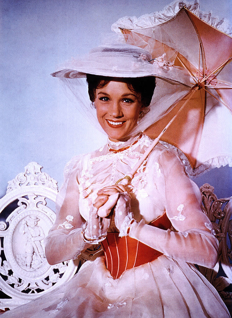 andrews holding a a small satin umbrella as mary poppins