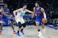 Detroit Pistons guard Cade Cunningham (2) brings the ball up court as Charlotte Hornets guard Vasilije Micic (22) defends during the second half of an NBA basketball game, Monday, March 11, 2024, in Detroit. (AP Photo/Carlos Osorio)