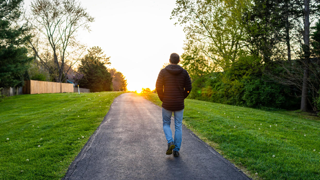  A man walking in a park. 