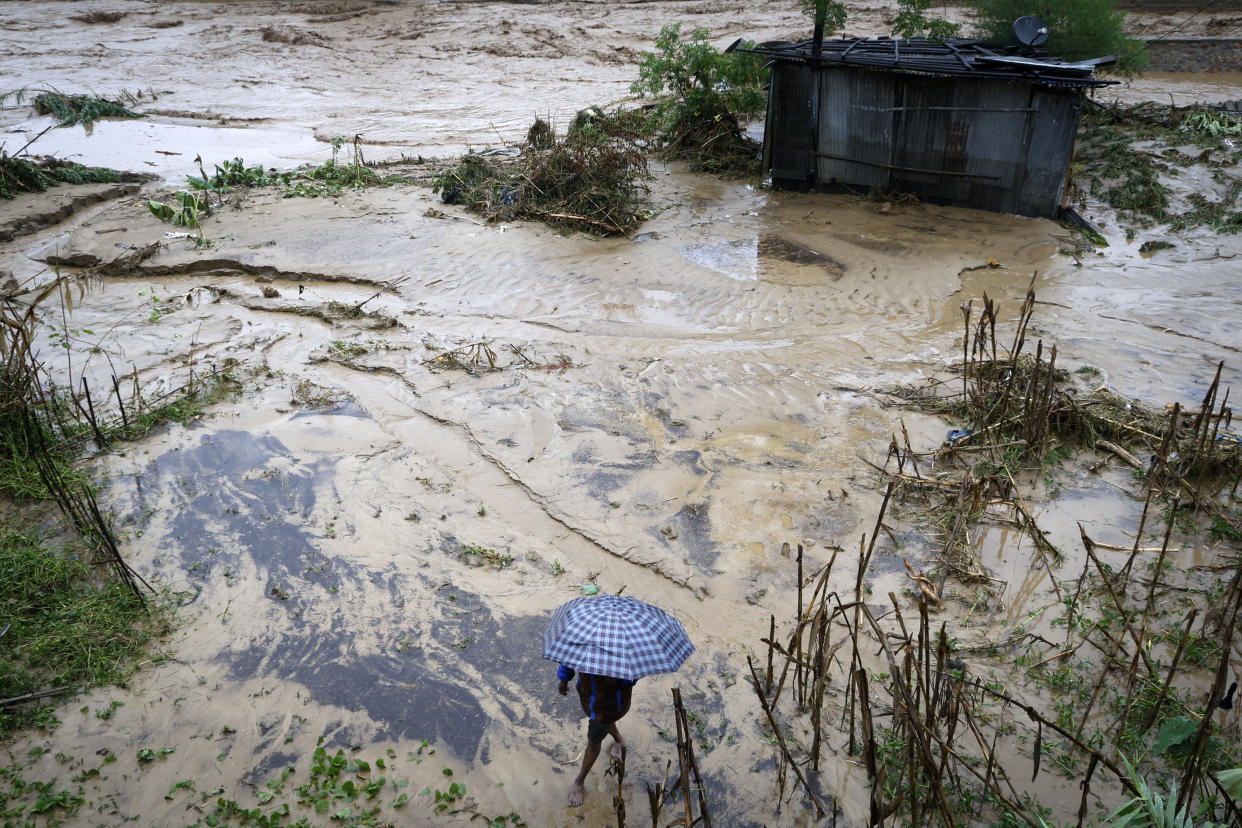 A man walks on the shore of the flooded Bagmati River after heavy rains in Kathmandu, Nepal, Saturday, Sept. 28, 2024. (AP Photo/Gopen Rai)