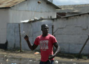 <p>An opposition supporter hurls a stone during clashes with police in the Jacaranda grounds quarter in Nairobi, Kenya, Tuesday, Nov. 28, 2017. (Photo: Brian Inganga/AP) </p>