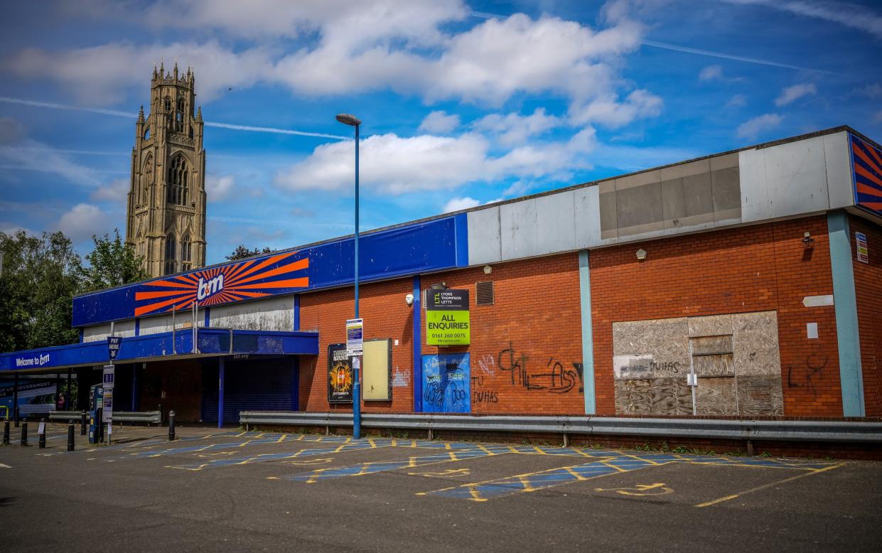 St Botolph's Church, known as the 'Boston Stump' behind a closed-down B&M store in Boston, England