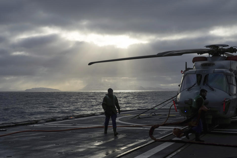 A mechanic prepares an helicopter for take-off aboard the French navy frigate Normandie during a patrol in a Norwegian fjord, north of the Arctic circle, Thursday March 7, 2024. The French frigate is part of a NATO force conducting exercises in the seas, north of Norway, codenamed Steadfast Defender, which are the largest conducted by the 31 nation military alliance since the cold war.(AP Photo/Thibault Camus)