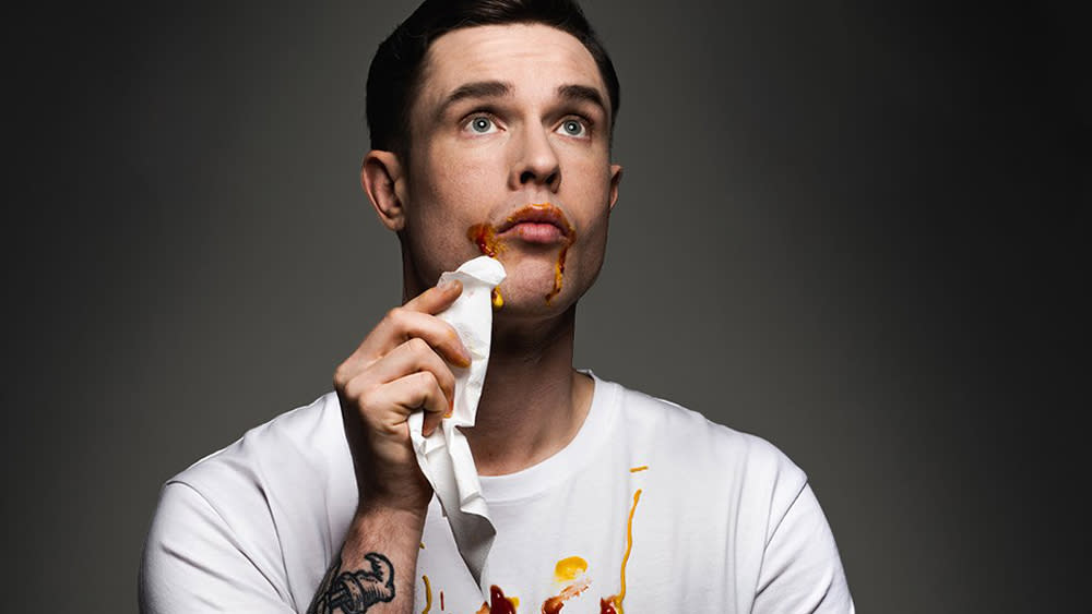  Detail from Ed Gamble poster showing the comedian with ketchup and mustard on his face and T-shirt. 