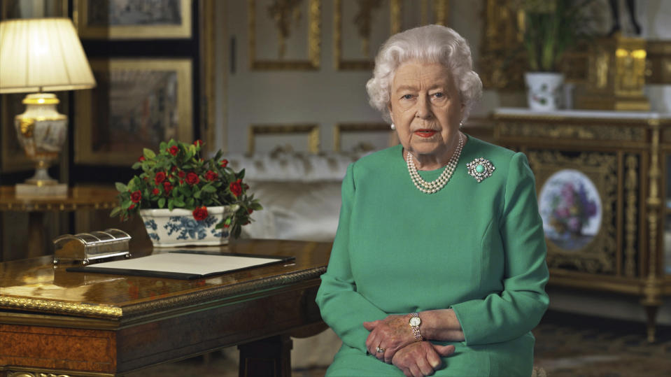 In this image taken from video and made available by Buckingham Palace, Britain's Queen Elizabeth II addresses the nation and the Commonwealth from Windsor Castle, Windsor, England, Sunday April 5, 2020. Queen Elizabeth II made a rare address, calling on Britons to rise to the challenge of the coronavirus pandemic, to exercise self-discipline in “an increasingly challenging time”. (Buckingham Palace via AP)