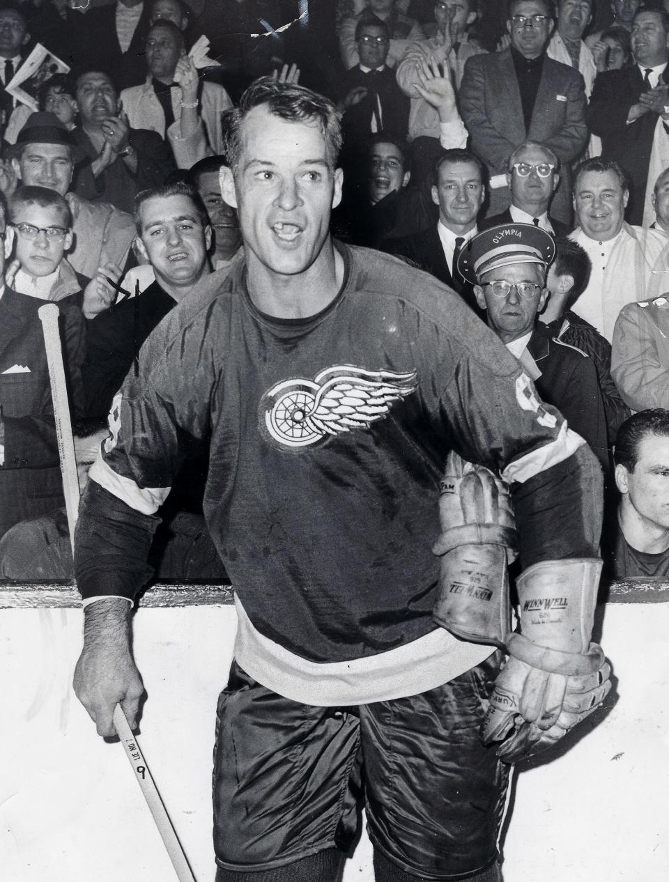 The fans cheer and chant as Gordie Howe relaxes after breaking Maurice “The Rocket” Richard’s record.