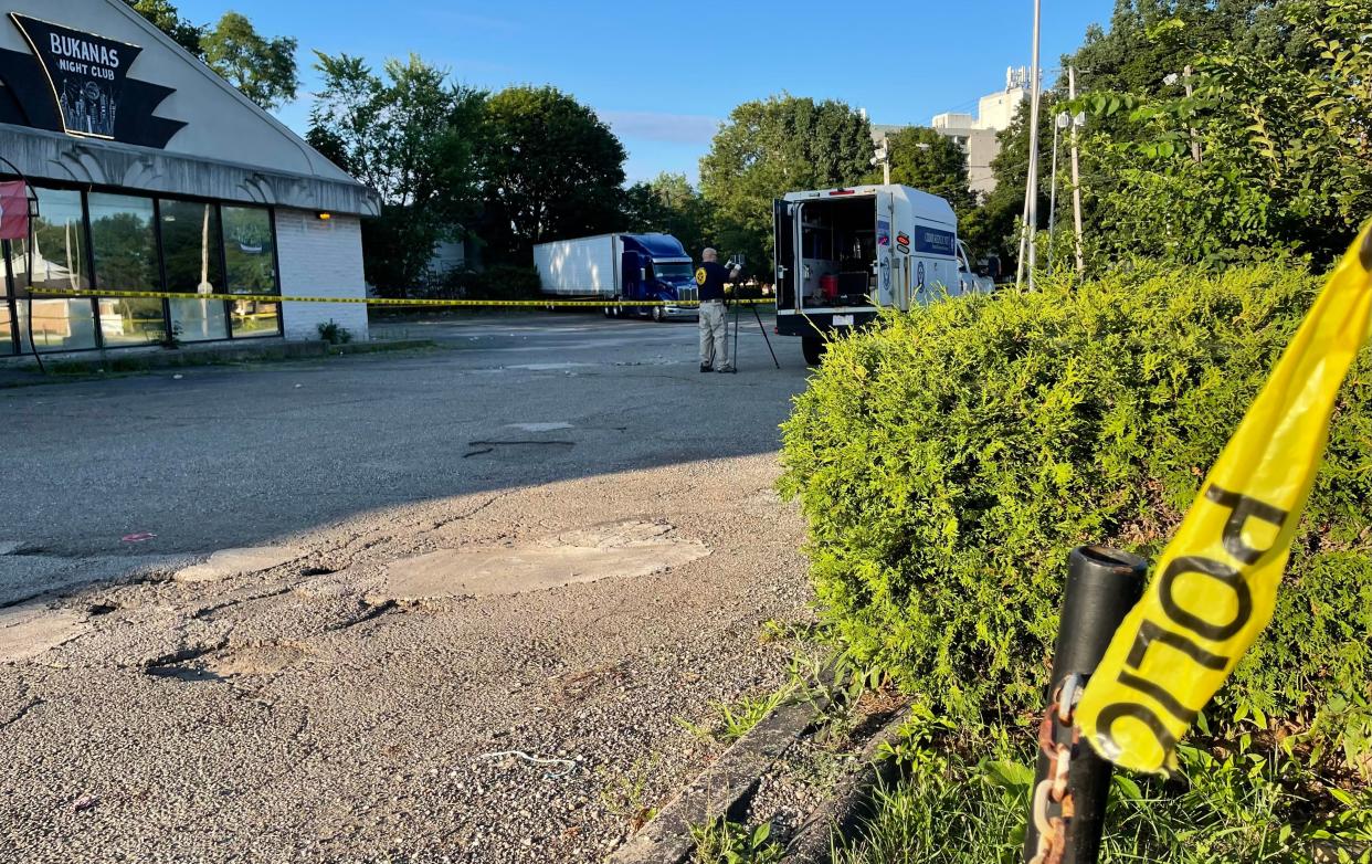 A member of the Ohio Bureau of Criminal Investigation Friday morning starts clearing up the parking lot scene at North Howard Street and Cuyahoga Falls Avenue where there was an Akron police officer-involved shooting earlier in the morning.