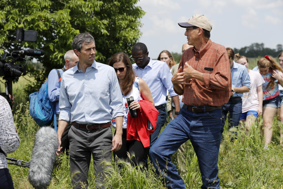 Democratic presidential candidate Beto O'Rourke talks with Matt Russell, right, while touring his Coyote Run Farm, Friday, June 7, 2019, in Lacona, Iowa. (AP Photo/Charlie Neibergall)