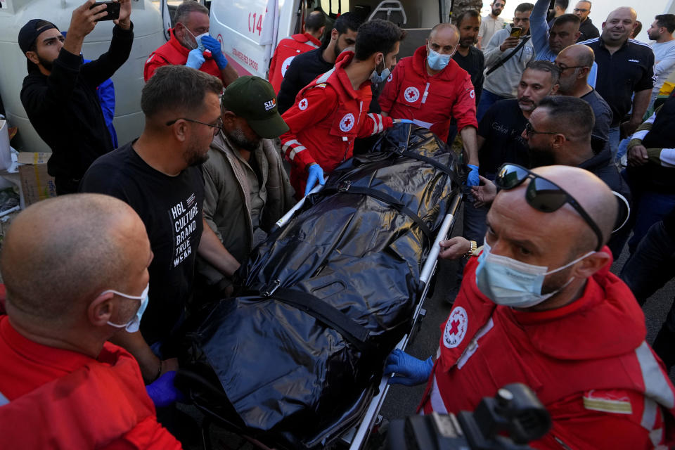 Lebanese Red Cross paramedics carry the body of Rabih Maamari, a cameraman at pan-Arab TV network Al-Mayadeen who was killed by an Israeli strike, at a hospital in Beirut, Lebanon, Tuesday, Nov. 21, 2023. An Israeli strike on southern Lebanon killed Tuesday two journalists reporting for the Beirut-based Al-Mayadeen TV on the violence along the border with Israel, according to the Lebanese information minister and their TV station. (AP Photo/Bilal Hussein)