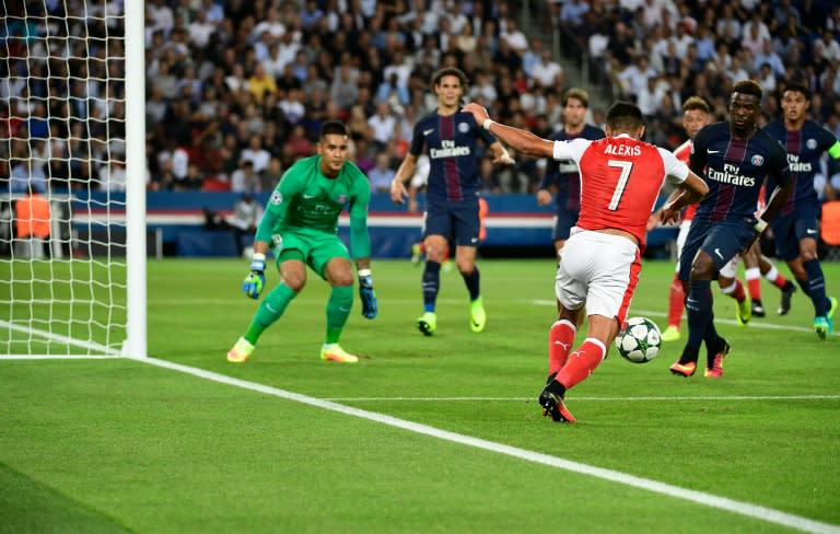 Arsenal's Chilean forward Alexis Sanchez (R) shoots during the UEFA Champions League Group A football match between Paris-Saint-Germain vs Arsenal FC, on September 13, 2016 at the Parc des Princes stadium in Paris