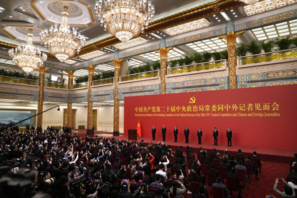 New members of the Politburo Standing Committee, from left, Li Xi, Cai Qi, Zhao Leji, President Xi Jinpgin, Li Qiang, Wang Huning, and Ding Xuexiang stand at the Great Hall of the People in Beijing, Sunday, Oct. 23, 2022. (AP Photo/Andy Wong)