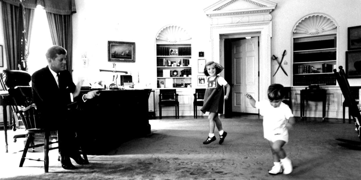 President John F. Kennedy clapping while watching his children dance in the Oval Office in 1963.