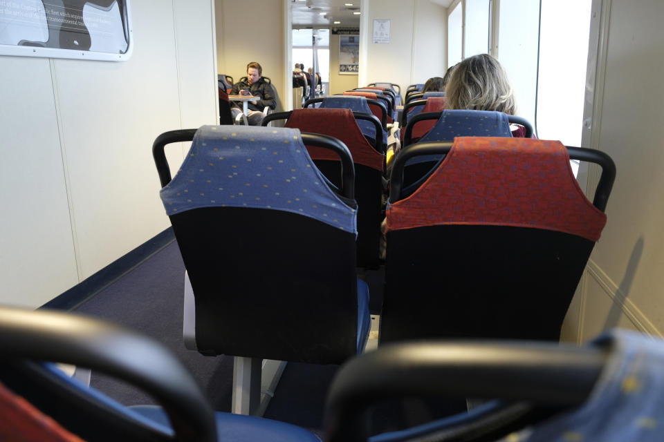 A number of seats are empty on the Golden Gate Ferry from Sausalito Thursday, March 12, 2020, as it makes its way into San Francisco. The ferry carried about one third of the normal amount of passengers Thursday. Gov. Gavin Newsom has issued sweeping, statewide "guidance" in response to the coronavirus pandemic, asking Californians to postpone all non-essential gatherings through the end of March, including even small social gatherings in places where people can't remain at least six feet apart. (AP Photo/Eric Risberg)