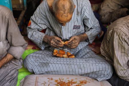 A displaced Iraqi man who was among the rescued at the site of battle eats bread at the positions of Iraqi forces at the Old City in Mosul, Iraq June 29, 2017. REUTERS/Erik De Castro