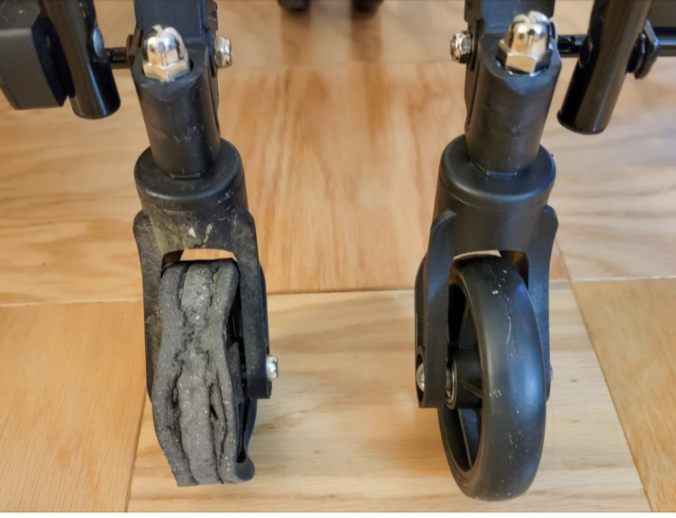 Close-up of a stroller's worn-out left wheel beside an intact right wheel, highlighting the need for maintenance