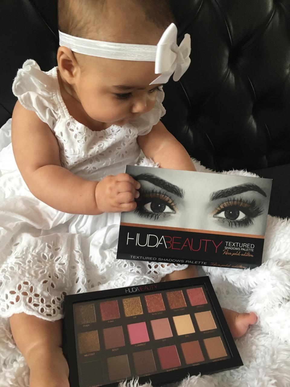 Kassia Mattis as a baby with Huda Beauty a eyeshadow palettes.